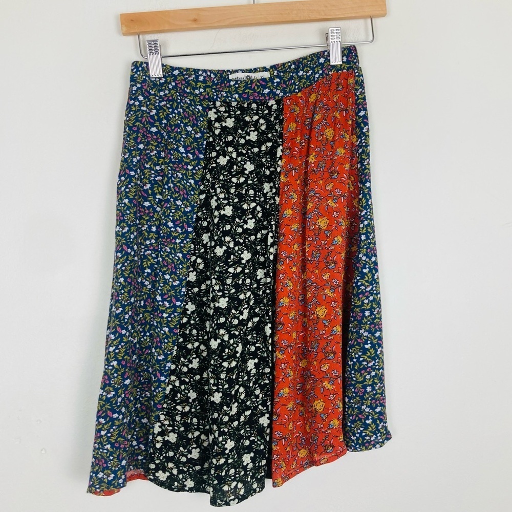 Natural Life mixed print, orange, black, and white knee length skirt. Size XS